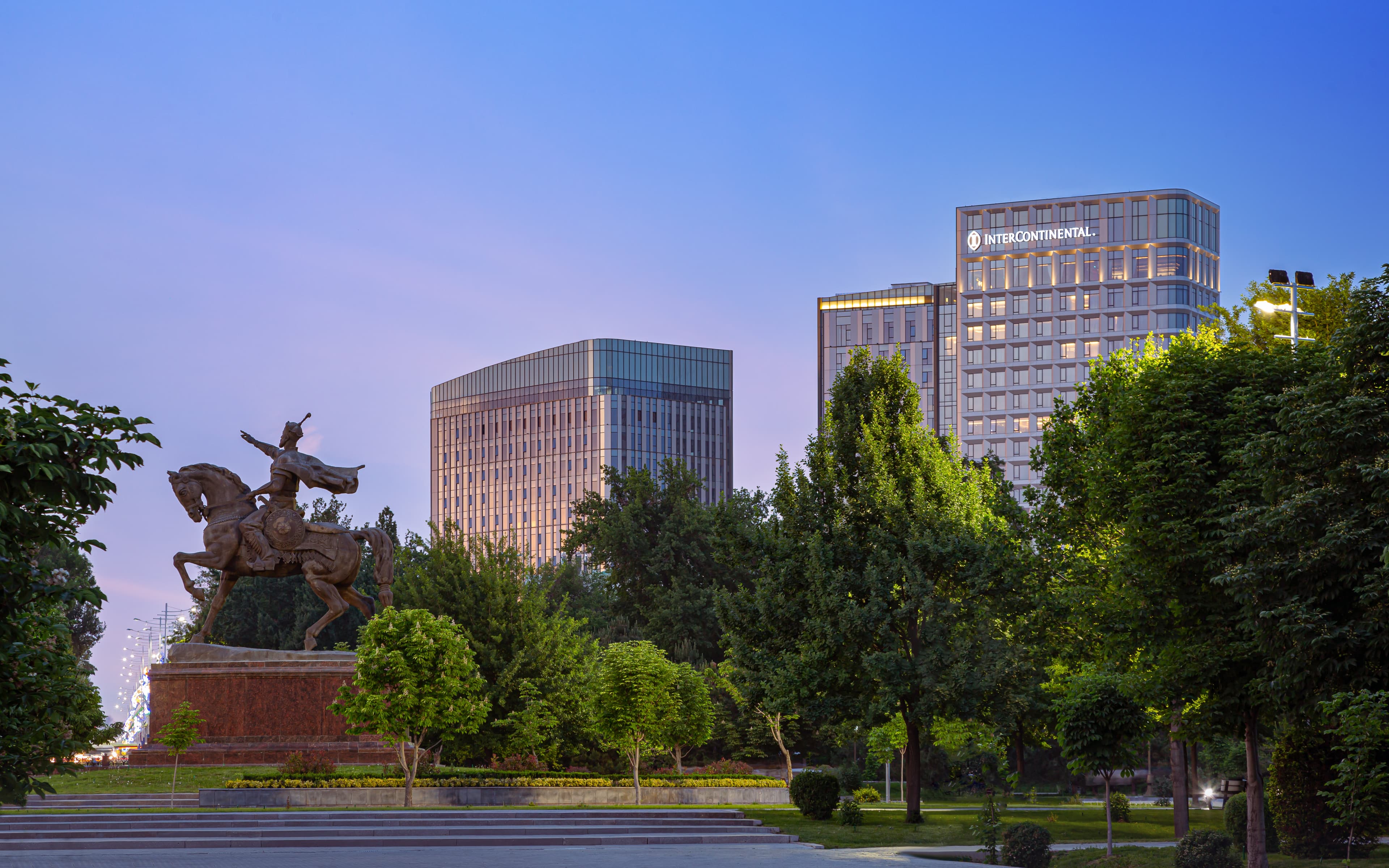 The hotel windows open up to the lush green Amir Temur Square.